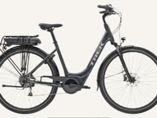 Dark gray Trek Verve+ 1 e-bike with step-through frame, rear rack with battery, and disc brakes shown in profile against white background.