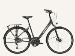 Dark gray Trek Verve 2 hybrid bicycle with rear rack, disc brakes, and suspension fork, shown in profile against white background.