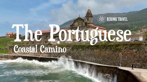 Kuststräcka med historisk kyrka och klocktorn bakom stenmur där vågor kraschar. Gröna kullar i bakgrunden. Textöverlägg 'The Portuguese Coastal Camino'.